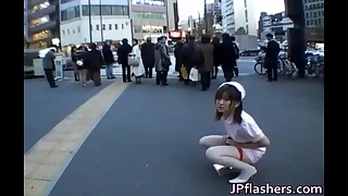 Naughty Asian girl is pissing button up by public